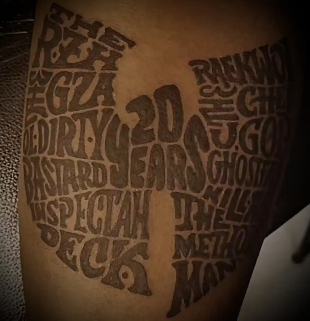 BL-ink Tattoo Colorado Springs Wu-Tang tribute: word-art W logo reading 20 Years and members’ names on upper arm